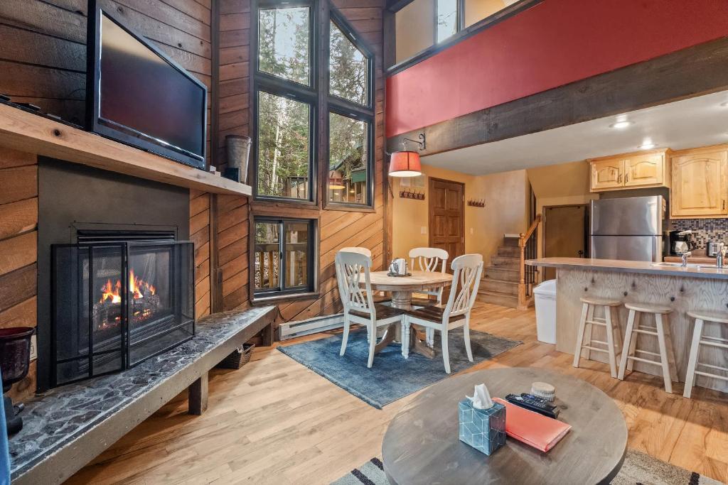 a living room with a fireplace and a table and chairs at Ski Access SS7B Retreat Pet Friendly in Brian Head