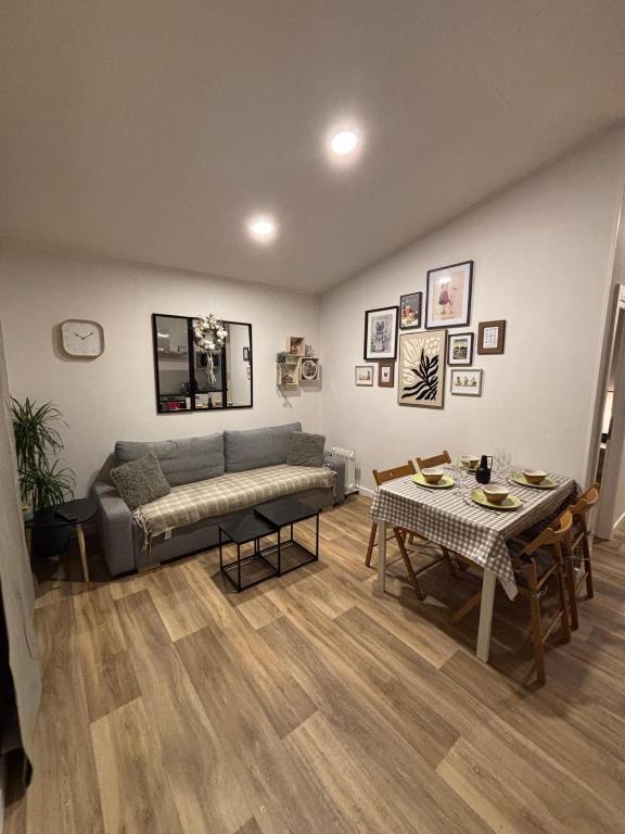 a living room with a couch and a table at LE PIED A TERRE SELESTADIEN in Sélestat