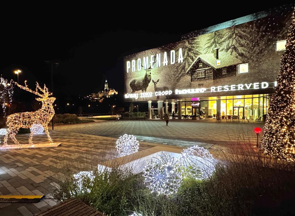 a shopping center with christmas lights in front of a building at PROMENADA Apartments with FREE PARKING in Nitra