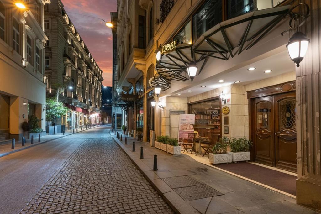 an empty street in a city at night at Taksim Pera Rose Hotel & Spa - Istiklal Street in Istanbul