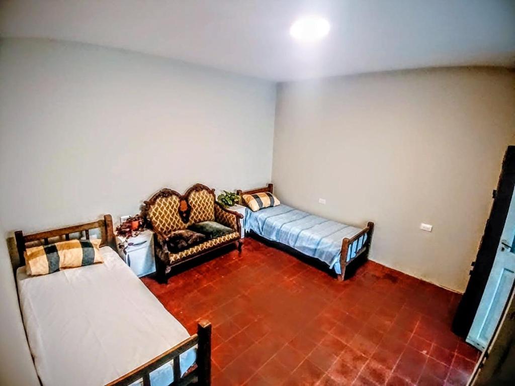 a living room with two beds and a couch at La Casona Hostel in Bermejo