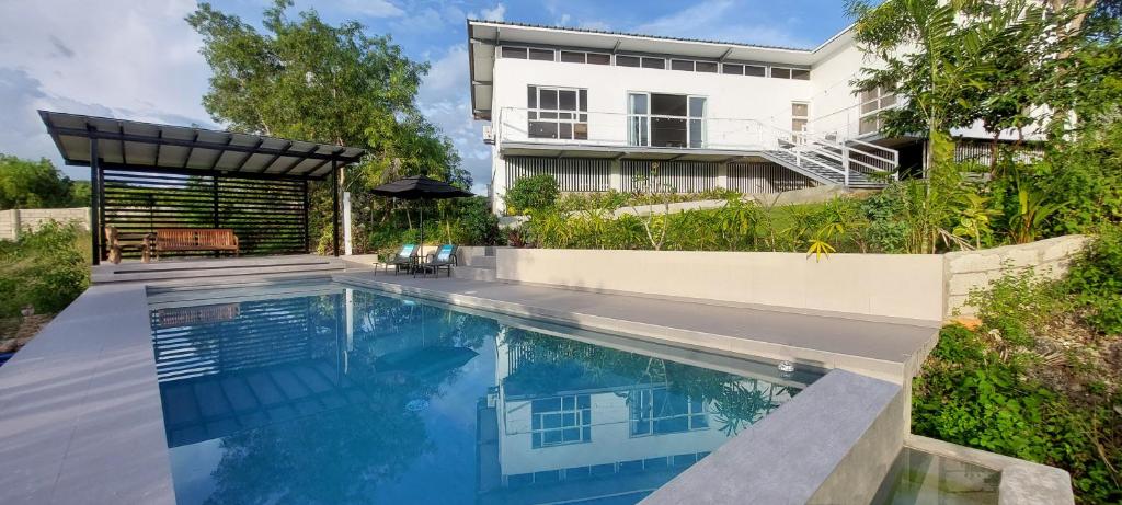 a swimming pool in front of a house at Kalma - 2 Bedroom Villa with Private Pool in Santander