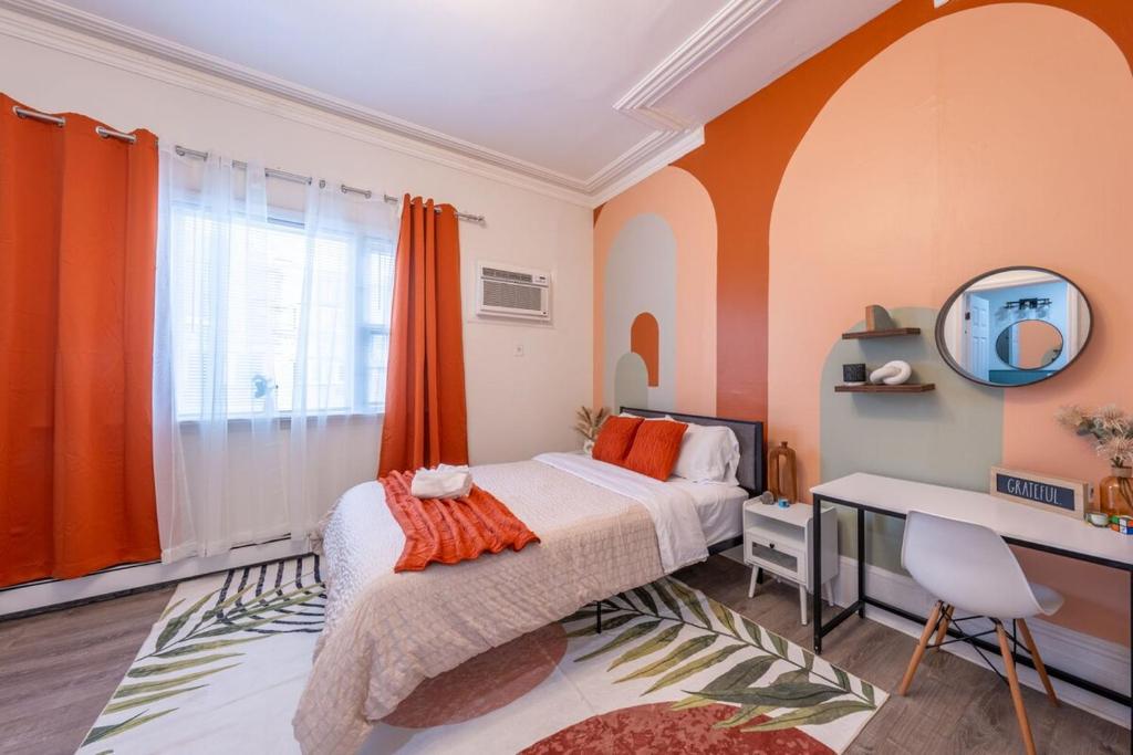 a bedroom with a bed and a desk and a mirror at 7BR 5BTH House Steps to Bars Dining NYC Access with GameRm Backyard with BBQ and Parking in Jersey City