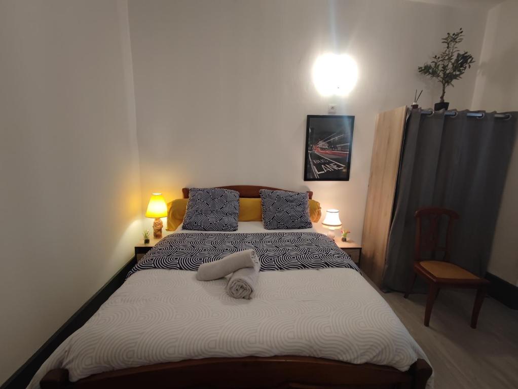 a bedroom with a bed with two towels on it at City 18 in Bourges