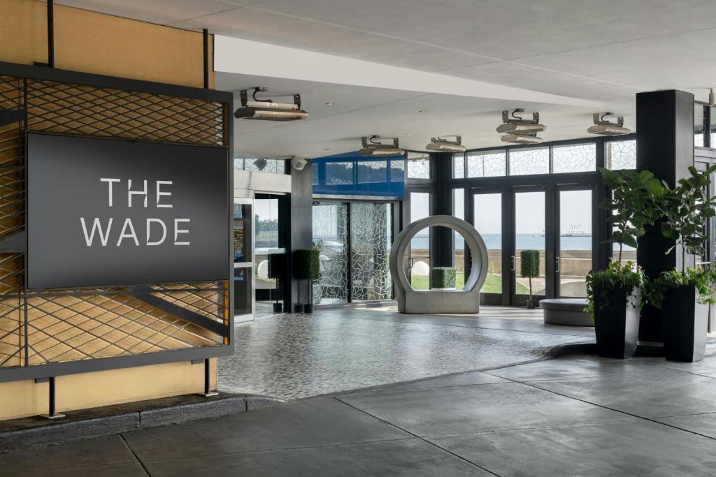 a lobby with a sign in the middle of a building at The Wade in Chicago