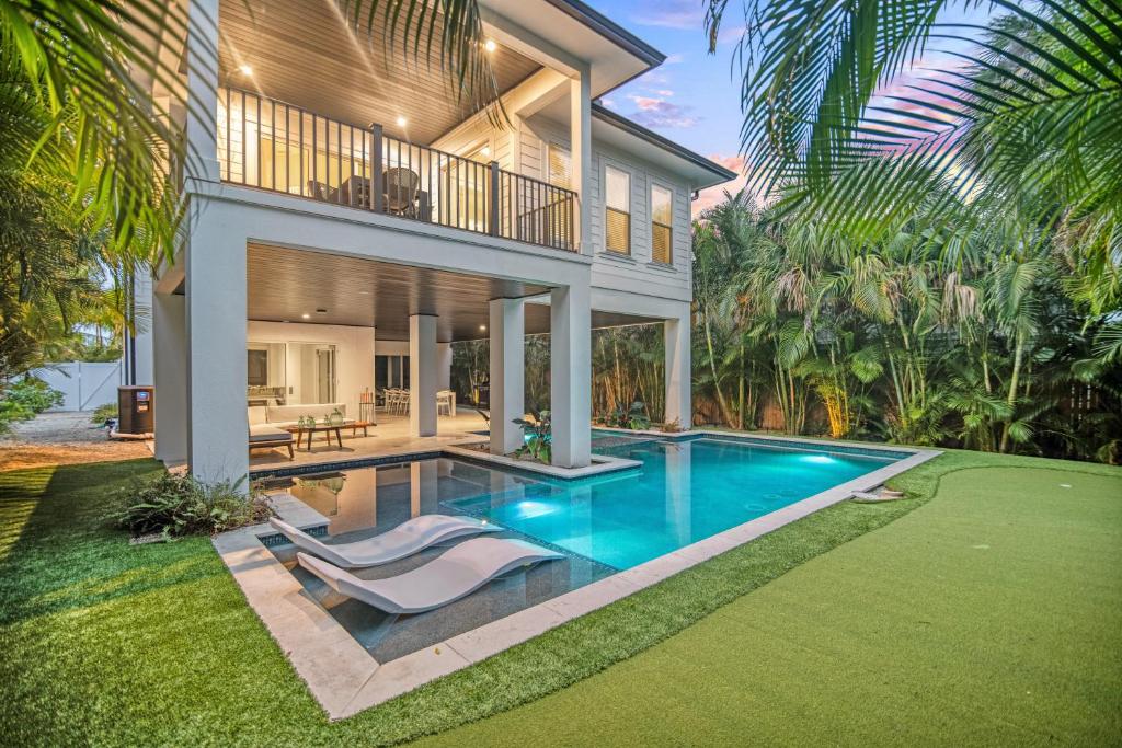 a house with a swimming pool in front of a house at Kays Landing - 423 in Anna Maria