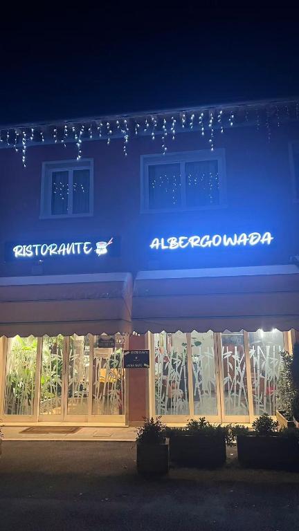 a blue sign on the front of a store at Hotel Ristorante Wada in Malo