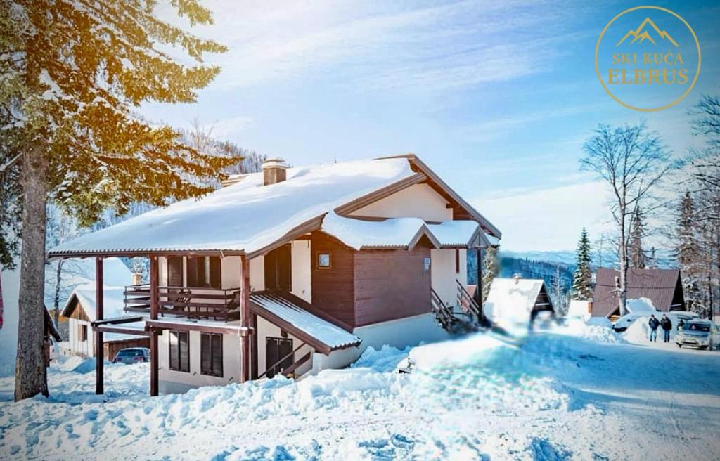 a house covered in snow with a roof at Ski kuca Elbrus in Jahorina