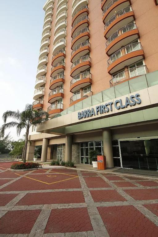 a large building with a first class sign on it at Apart hotel Barra First in Rio de Janeiro
