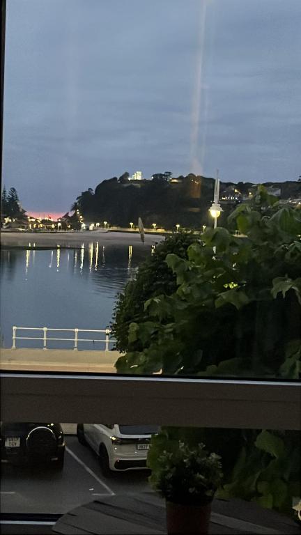 a window with a view of a body of water at Alojamientos Boutique Ribadesella in Ribadesella