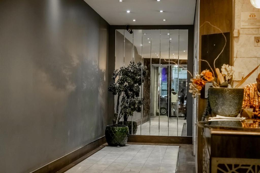 a lobby of a store with a window and plants at Cosmic Leopard in Cape Town
