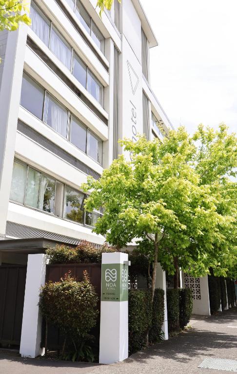 a building with trees in front of it at Noa Hotel in Auckland