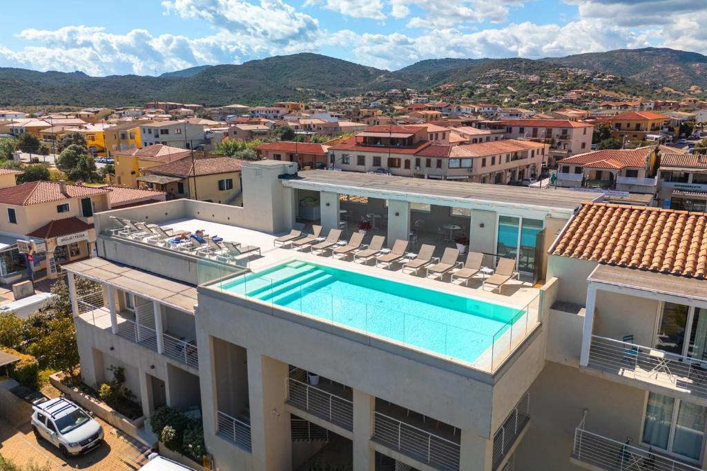 an aerial view of a building with a swimming pool at ISA - Residence with panoramic swimming pool in Porto San Paolo just 850 mt from the sea in Porto San Paolo