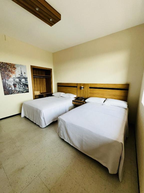 Ένα ή περισσότερα κρεβάτια σε δωμάτιο στο Hotel Calvete