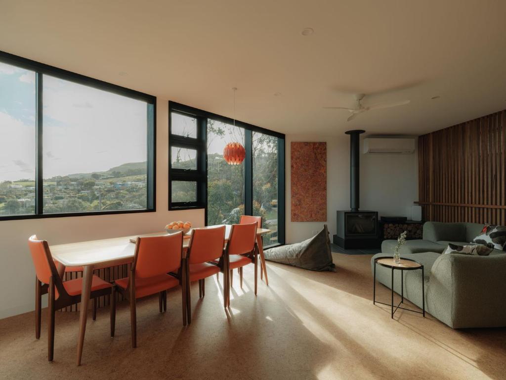 a living room with a table and chairs and a couch at Obliqua in Skenes Creek