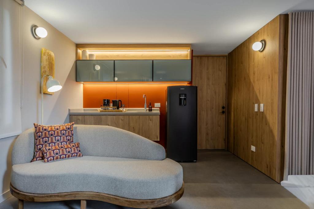 a living room with a couch and a refrigerator at NOK Luxury 3BR in Bogota with Terrace in street 84 in Bogotá