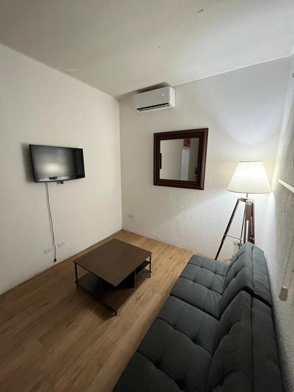 a living room with a couch and a table at Departamento Privado en Los Cabos in San José del Cabo