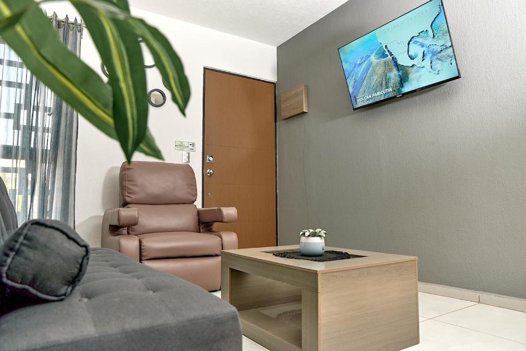 a living room with a couch and a chair at Casa Los Tules No 10 in Ciudad Guzmán