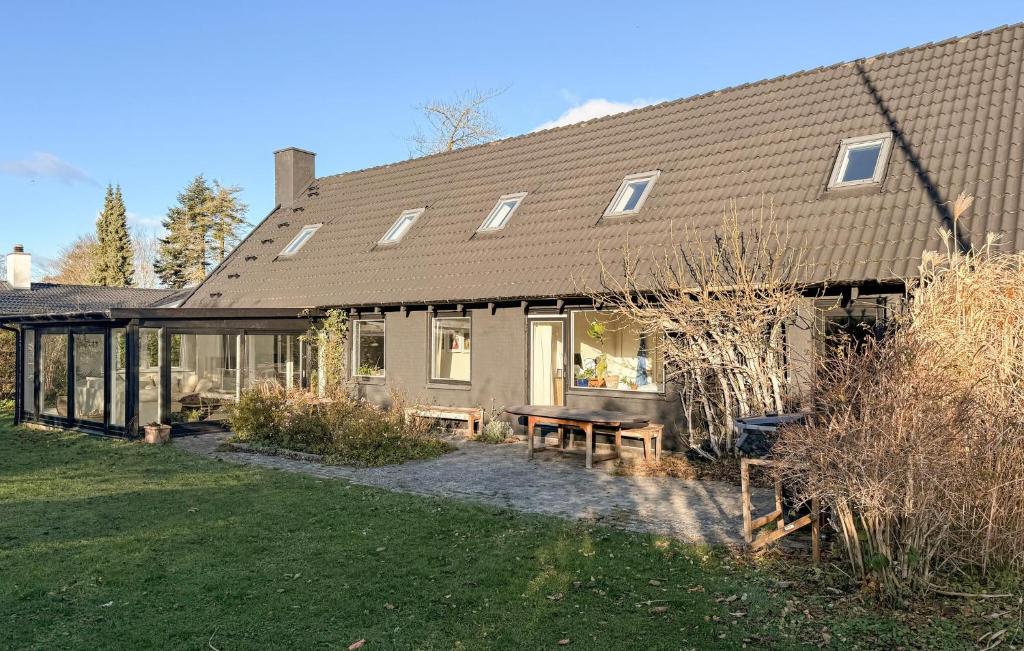 a house with a picnic table in front of it at 5 Bedroom Beautiful Home In Gilleleje in Gilleleje