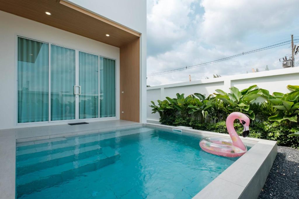 a swimming pool with a pink flamingo in a house at Minimalistic Pool Villa in Ao Nang 