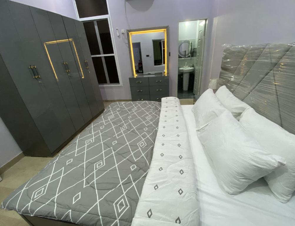 卡拉奇Modern Executive Suite的卧室里有一张大床，配有白色枕头