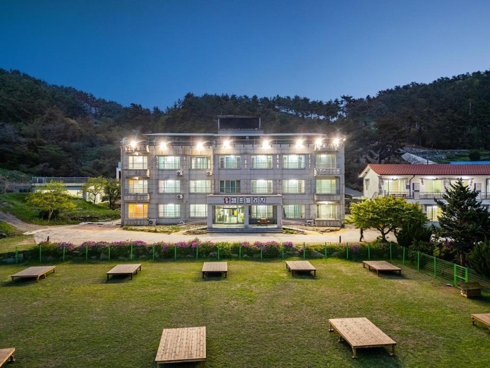 a large building with benches in front of it at Namhae Camp Village in Namhae