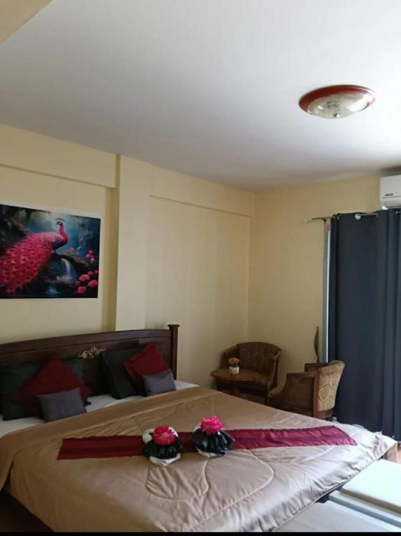 a bedroom with a bed with red bows on it at The Sunshine hostel and hotel in Ko Lanta
