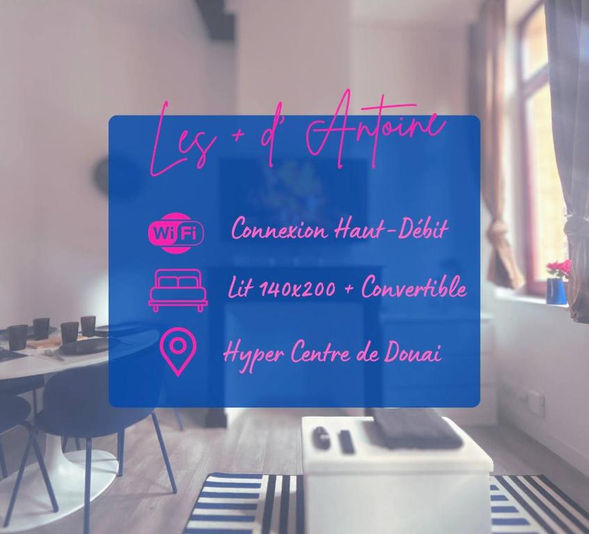 a sign in a room with a desk and a table at Le basque in Douai