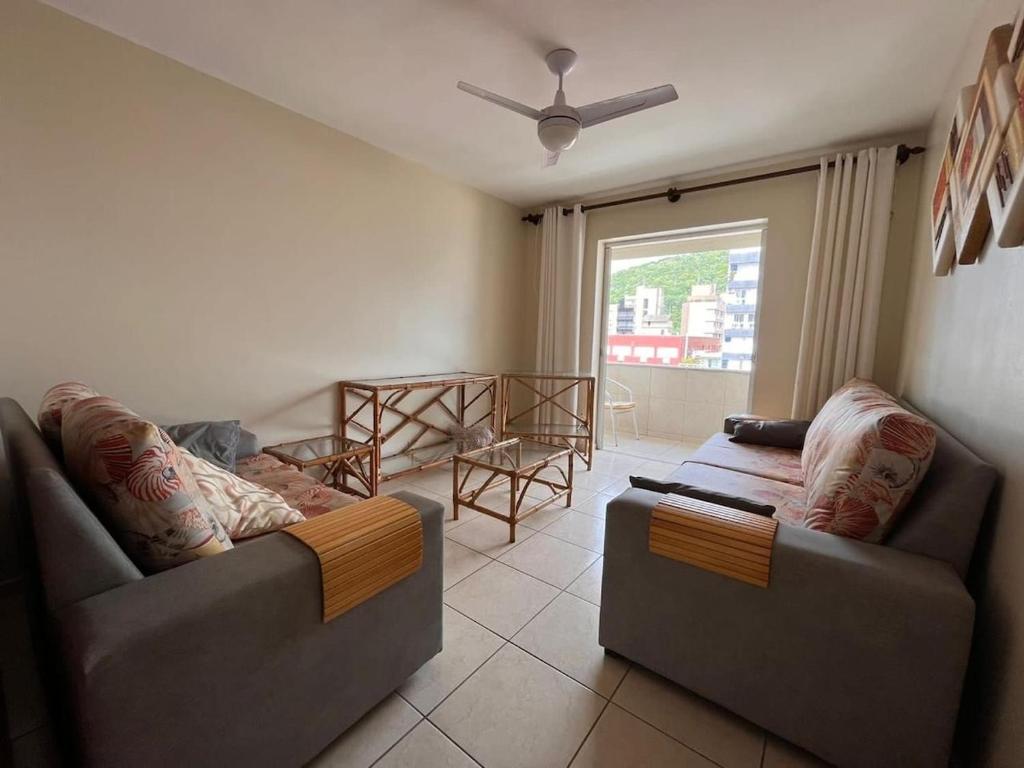 a living room with two couches and a window at Apt Praia Mansa Don in Matinhos