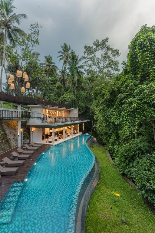 an exterior view of a resort with a swimming pool at The Ning Resort Ubud in Ubud