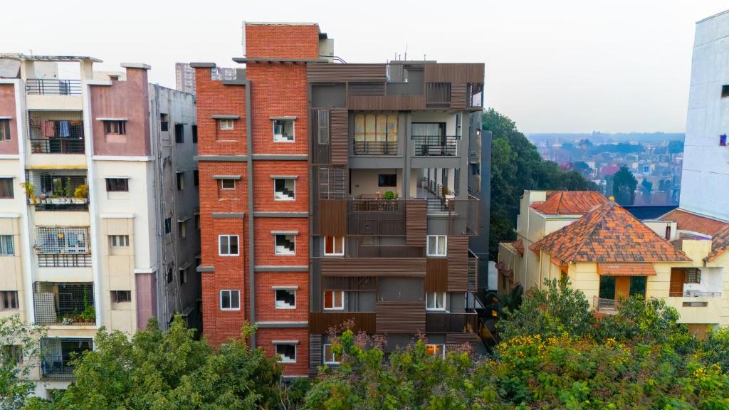 a tall building with balconies in a city at Trunk and Trolley, Gachibowli, A Luxury Boutique Hotel, Hyderabad in Hyderabad
