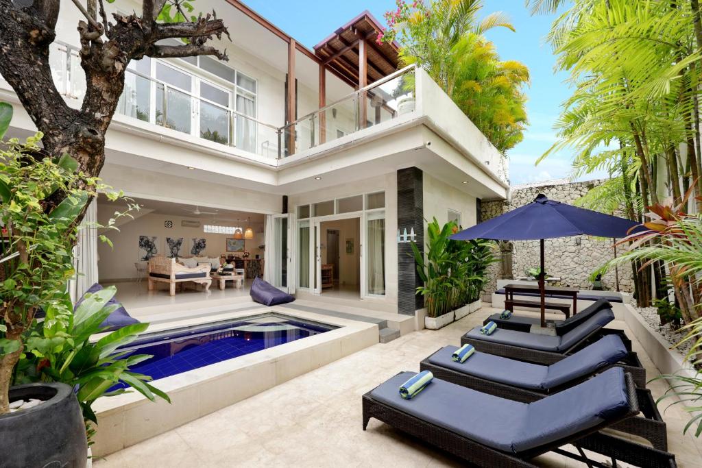 an exterior view of a house with a swimming pool at Villa Alba in Seminyak