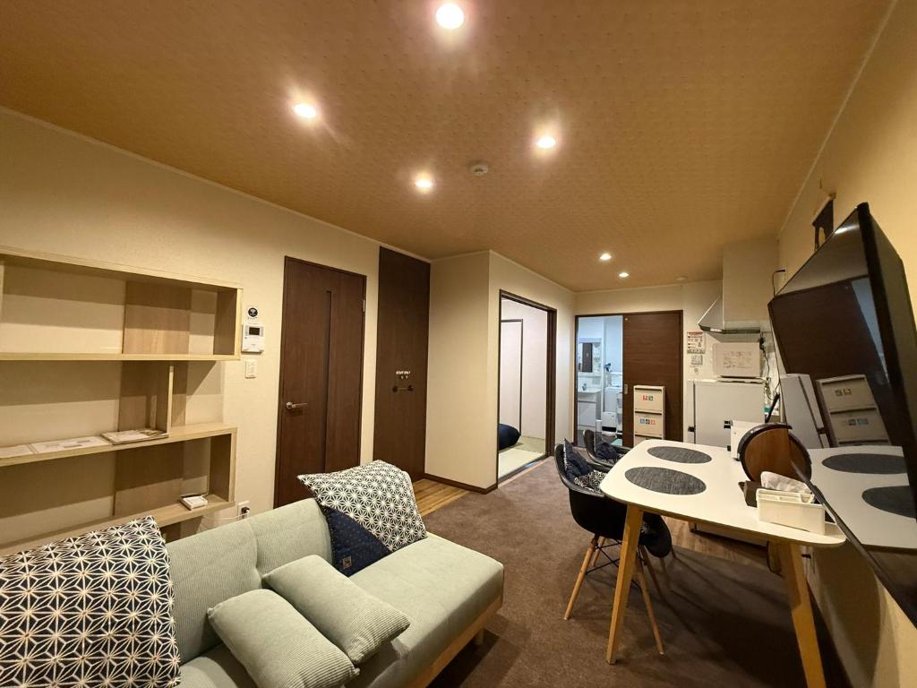 a living room with a couch and a table at Vieuno Hida Takayama in Takayama