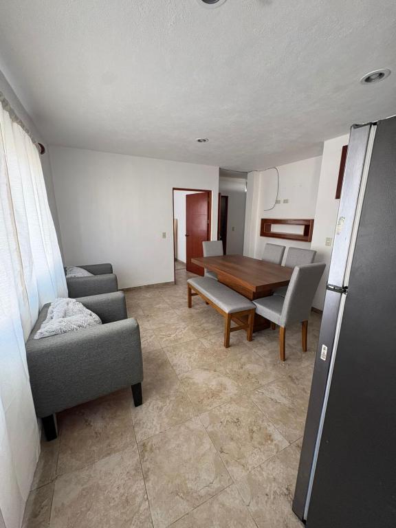 a living room with a couch and a table at Alcalá in Atlixco