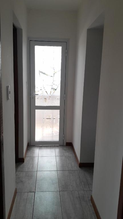 an empty room with a door with a large window at Namaste in Olavarría