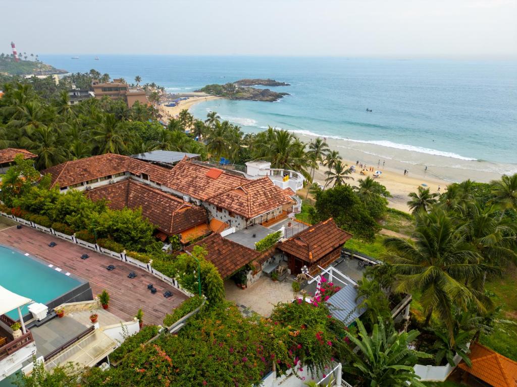 an aerial view of a resort and the beach at By The Bay Kovalam in Trivandrum