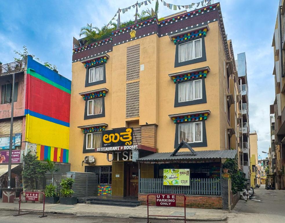 a building with a sign on the side of it at Open Hotel by Olive - Utse Suites in Bengaluru