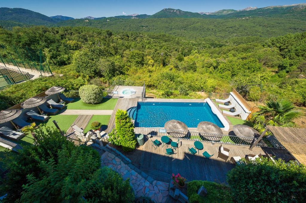 an aerial view of a swimming pool in a resort at Hotel Le Tourisme in Zonza