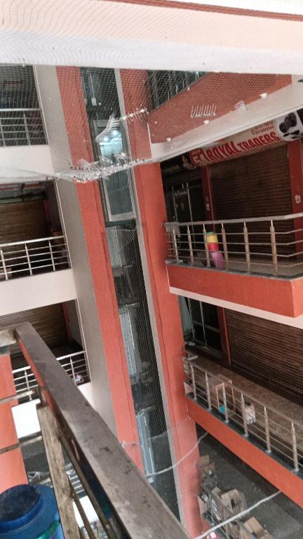 an aerial view of an apartment building with the windows shattered at Hotel Laxmi Nagar in Dera Bassi