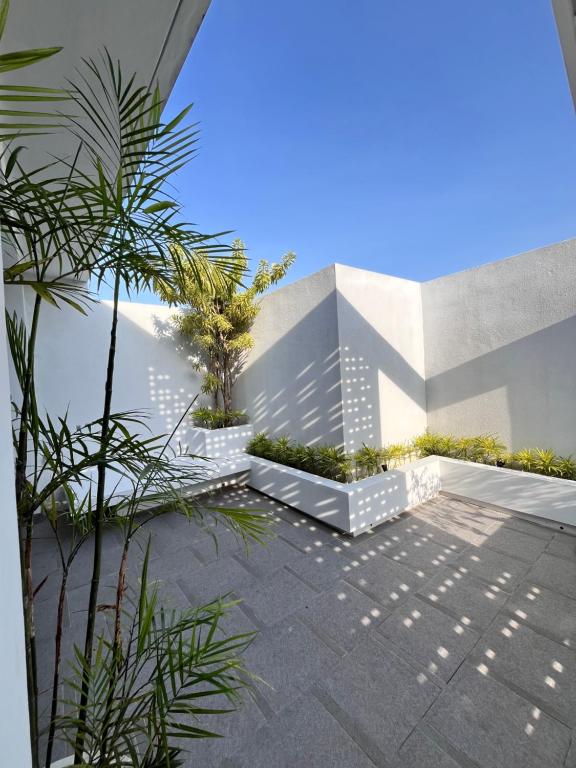 a courtyard with trees and plants in a building at Villa Jasmine in Seminyak
