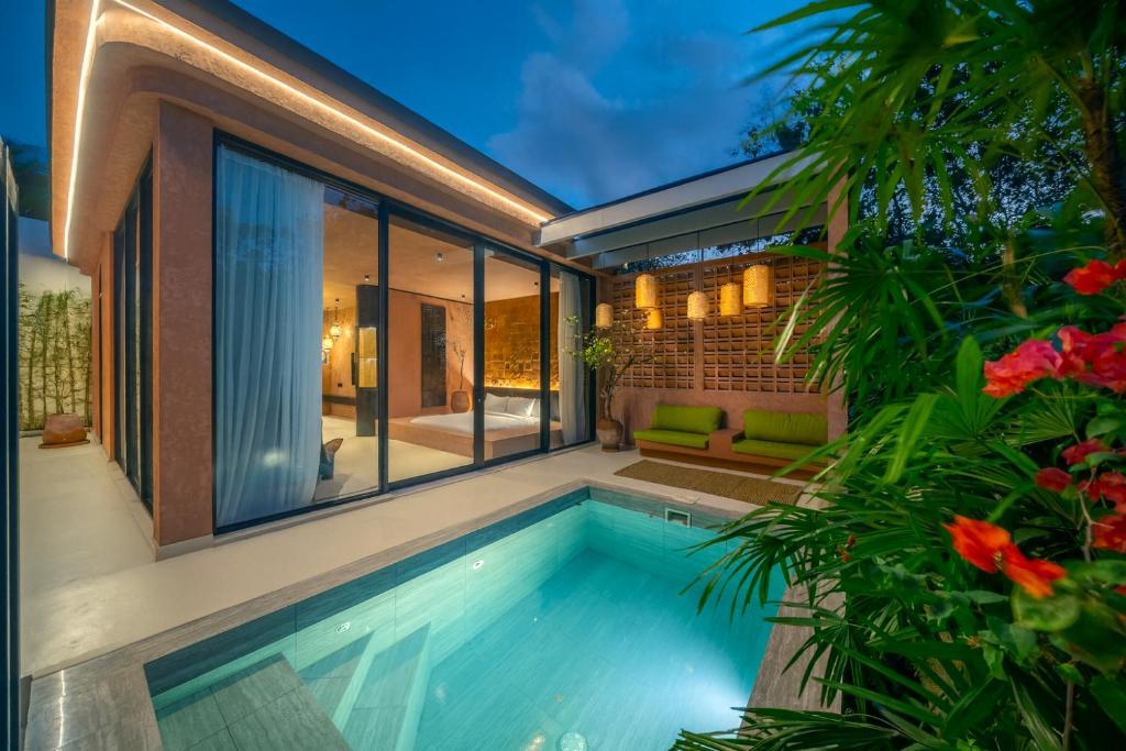 a swimming pool in the backyard of a house at Fengshui-1 Serene 1BR Stay in Ungasan in Uluwatu