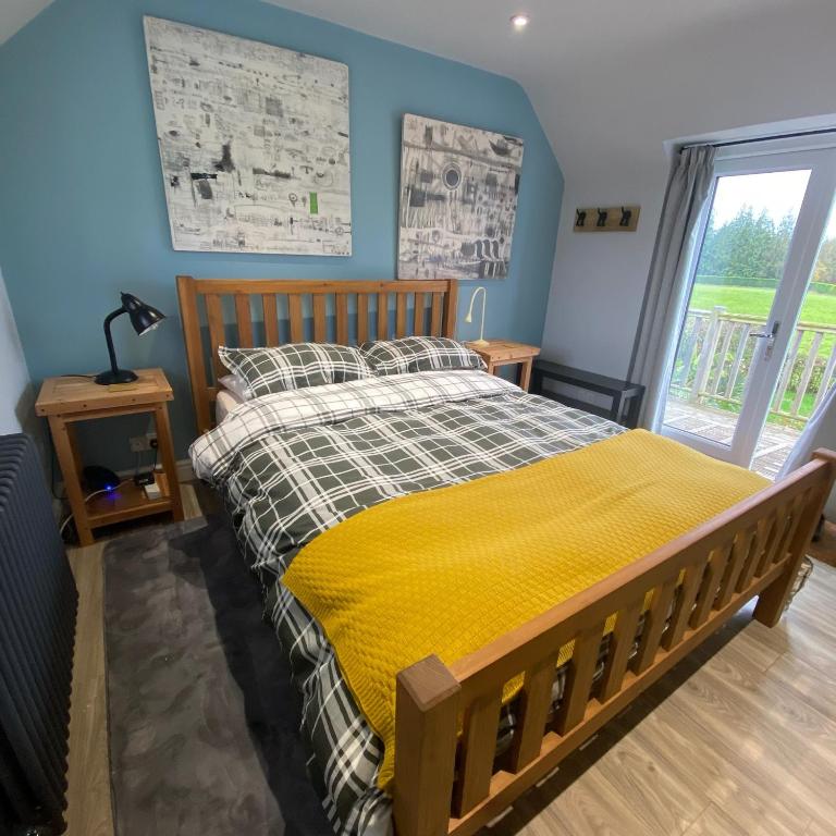 a bedroom with a bed with a yellow blanket at Cold Kitchen View in Longbridge Deverill
