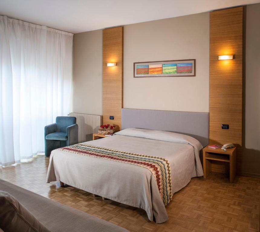 Postel nebo postele na pokoji v ubytování Hotel Clarici