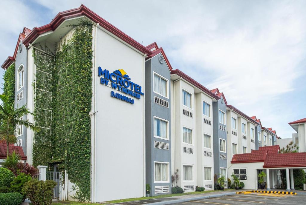 a rendering of the front of a hotel at Microtel by Wyndham Batangas in Santo Tomas