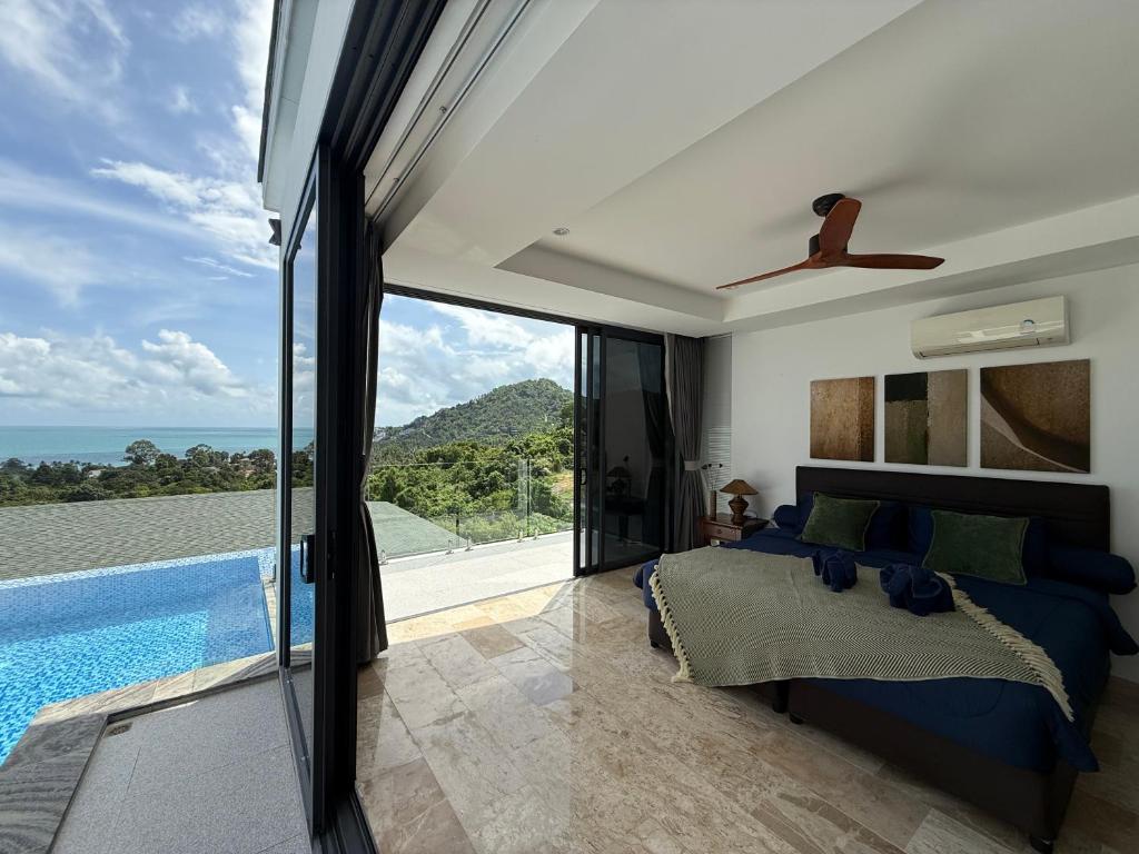 a bedroom with a bed and a swimming pool at Sea view Villa Josefina - 3 bedroom in Nathon Bay