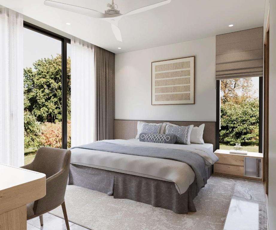 Un dormitorio con una cama y una ventana grande. en Gaia Eco Suites, en Phu Quoc