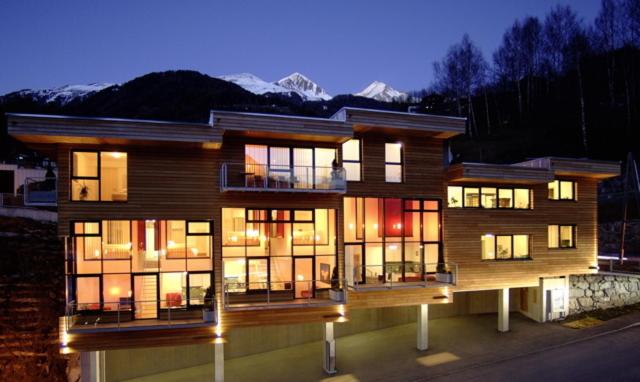 a large building with many windows at night at **** PanoramA Apartments in Matrei in Osttirol