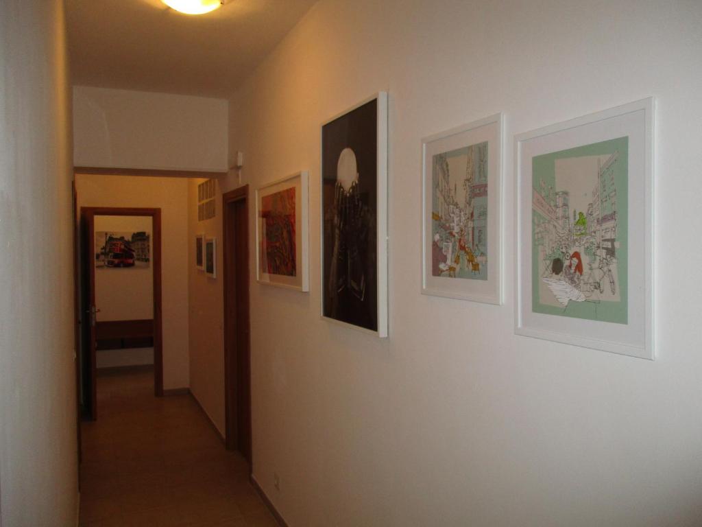 einen Flur mit Gemälden an den Wänden eines Zimmers in der Unterkunft Fatamorganamessina in Messina