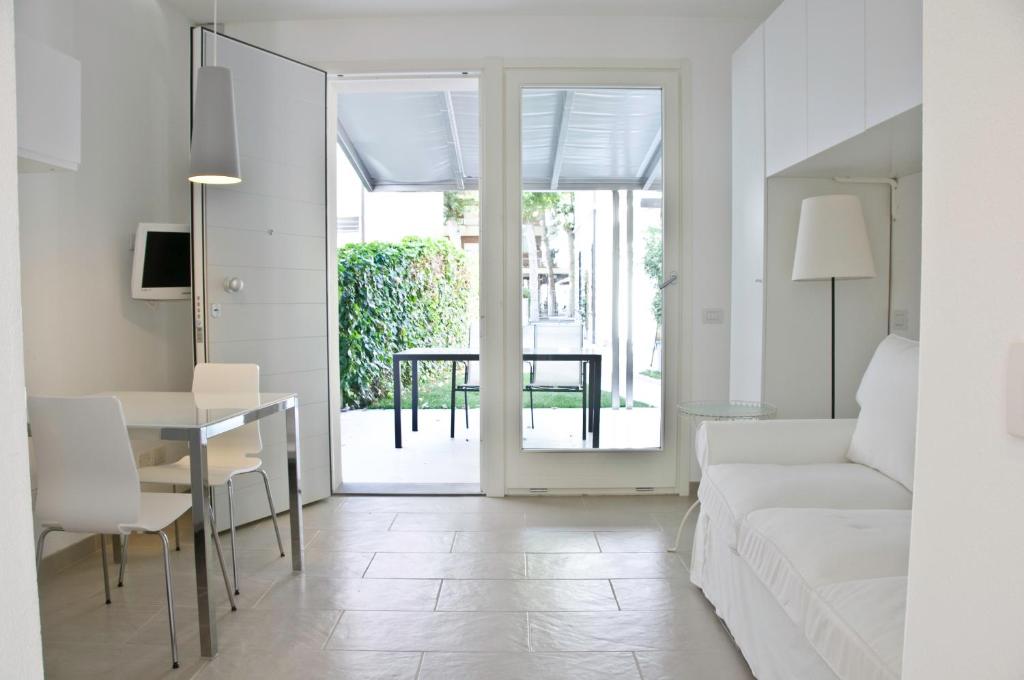 a living room with a couch and a table at Eco Apartments Cervia in Cervia
