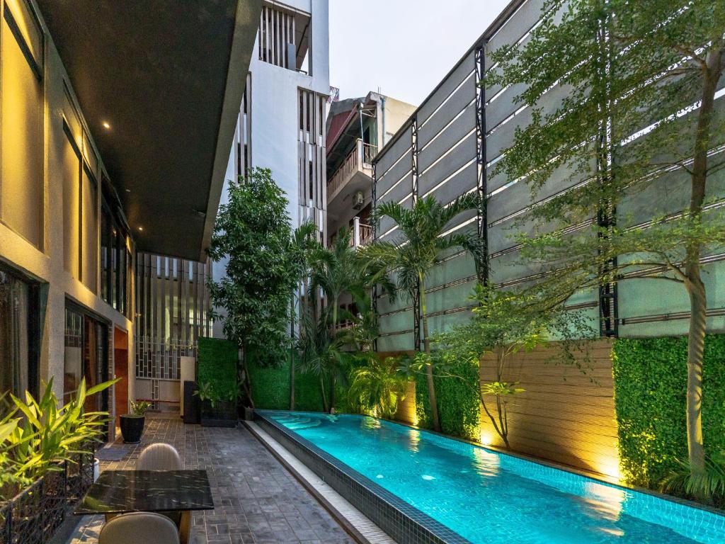 ein Innenhof mit einem Swimmingpool in einem Gebäude in der Unterkunft CHECK inn Phnom Penh BKK1 in Phnom Penh